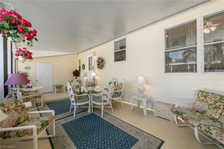 Sunroom featuring vaulted ceiling.  FURNITURE STAYS