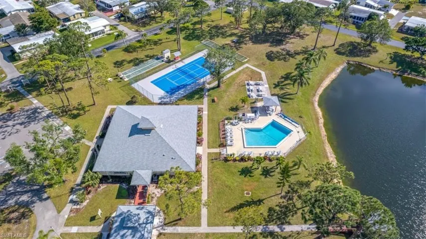 Aerial view featuring the clubhouse, tenni courts and pool area