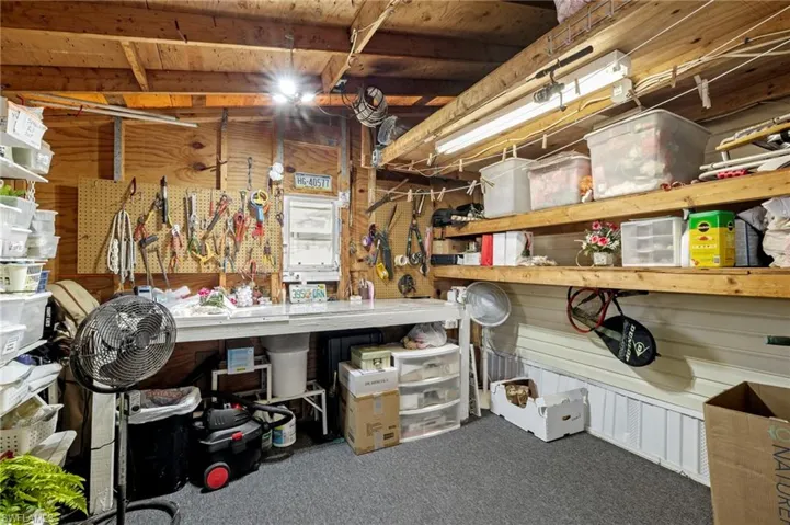 View of storage area with lots of shelves for storage.