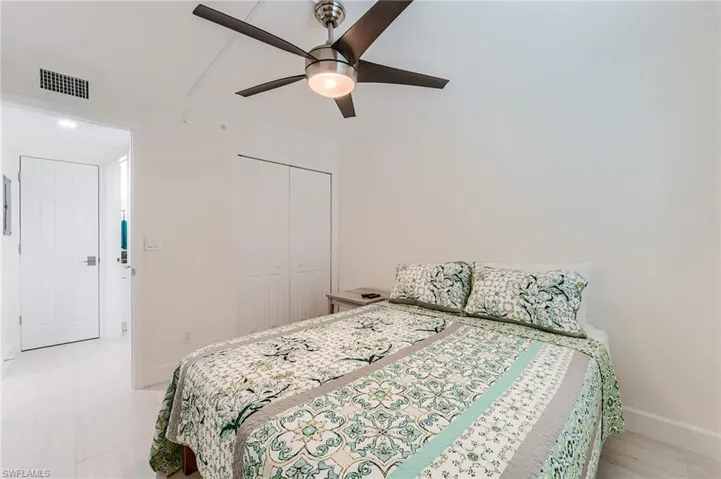 Bedroom featuring ornamental molding, a ceiling fan, and a closet