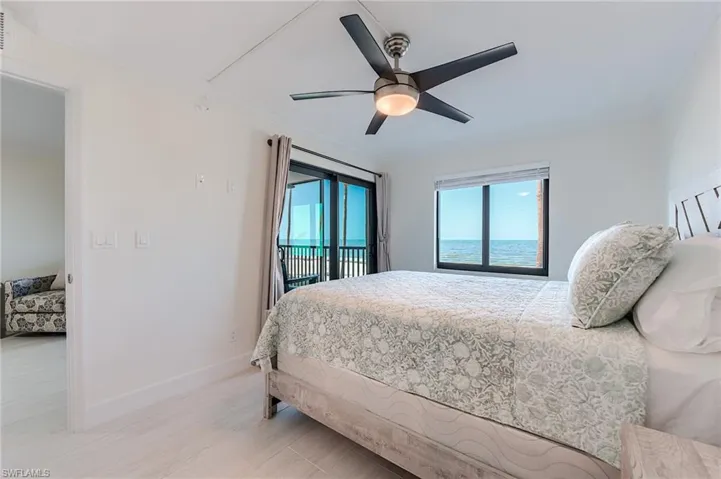 Bedroom featuring access to exterior, crown molding, and ceiling fan