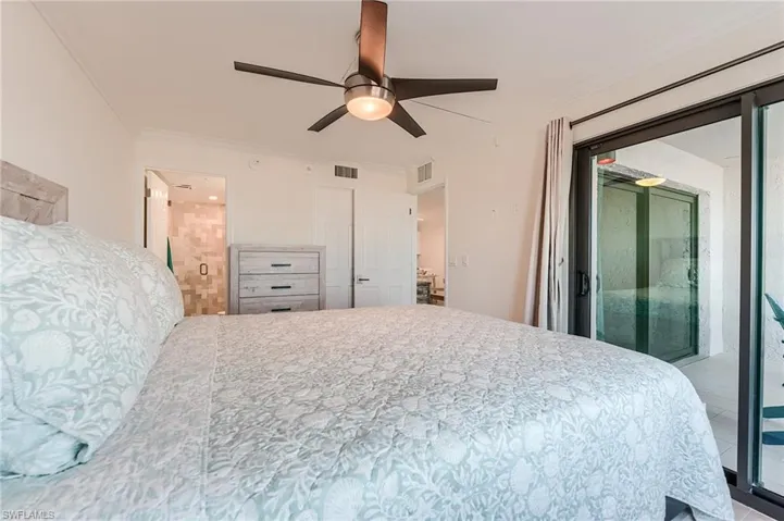 Bedroom featuring access to exterior, crown molding, a ceiling fan, and ensuite bathroom
