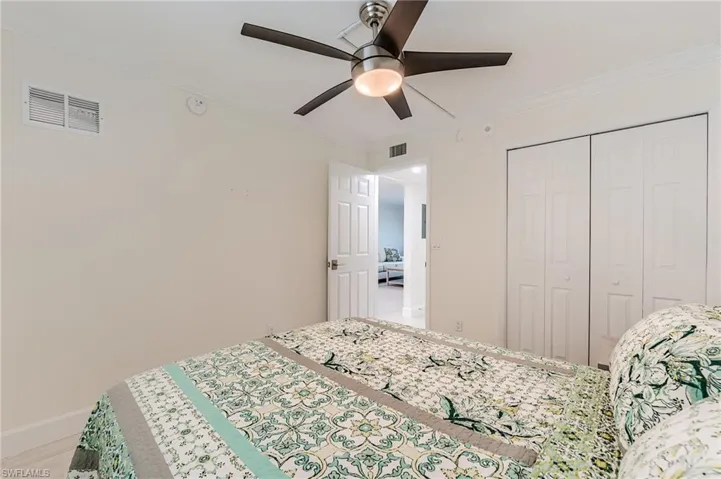 Bedroom with crown molding, a closet, and ceiling fan