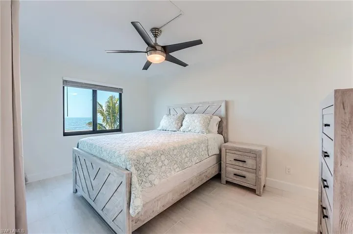 Bedroom with ornamental molding and ceiling fan