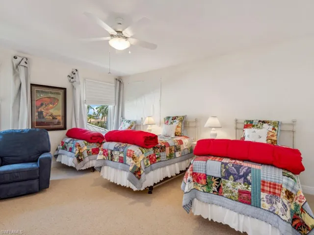Carpeted bedroom featuring a tray ceiling, access to outside, ceiling fan, baseboards, and crown molding