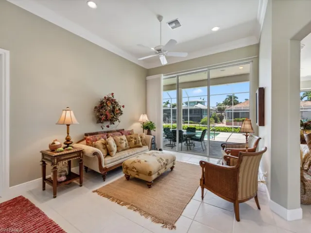 Living area with crown molding, ceiling fan, light tile patterned floors, a sunroom, and recessed lighting