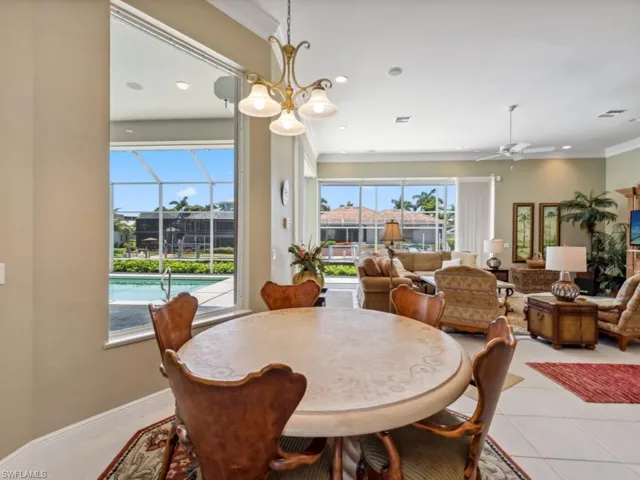 Dining space with ceiling fan, light tile patterned floors, recessed lighting, and ornamental molding