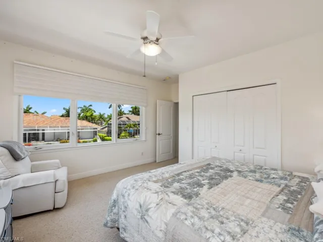 Carpeted bedroom featuring a closet, baseboards, and a ceiling fan
