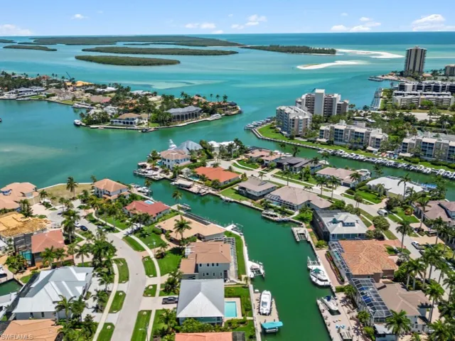 Aerial view of residential area featuring a nearby body of water