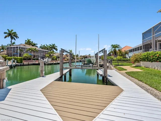 Dock area featuring boat lift and a water view