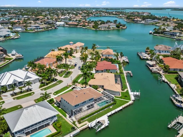 Aerial perspective of suburban area featuring a large body of water
