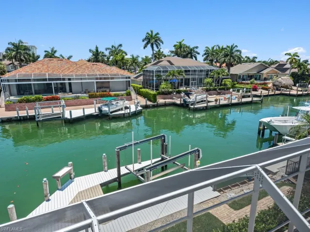 Dock area with a water view and boat lift