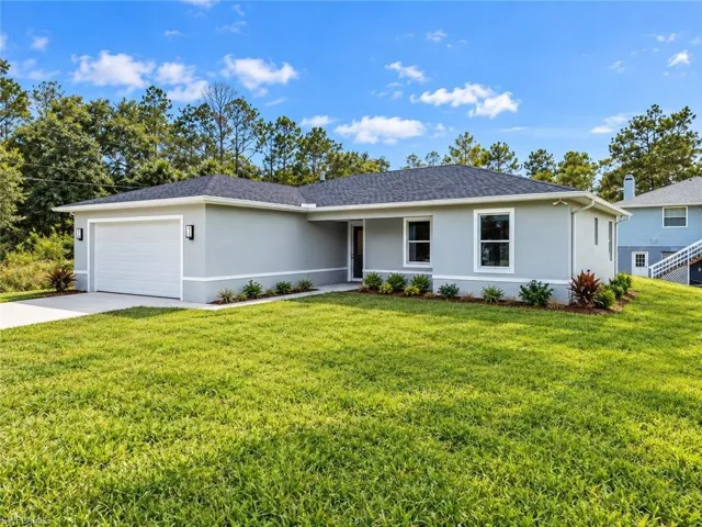 Single-story residence featuring light gray exterior, white trim, and a dark shingle roof