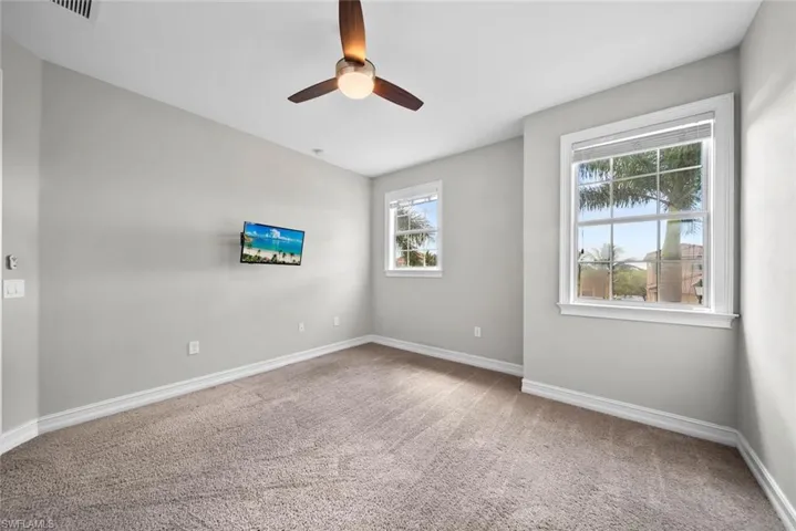 2nd floor bedroom featuring plenty of natural light, ceiling fan, and carpet floors