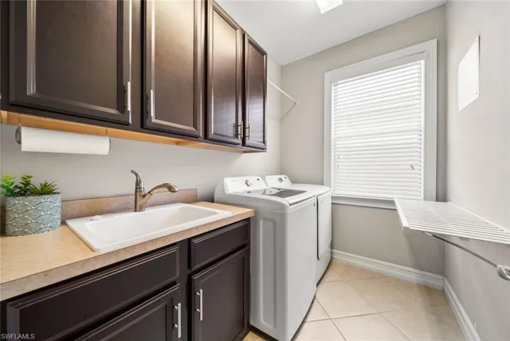 Laundry room with abundant storage, utility sink and washer dryer.