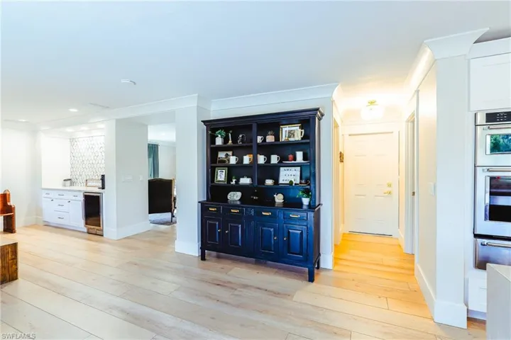 Hutch in kitchen area, hallway leading to garage, laundry room, and half bath