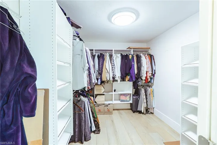 Spacious closet with wood finished floors