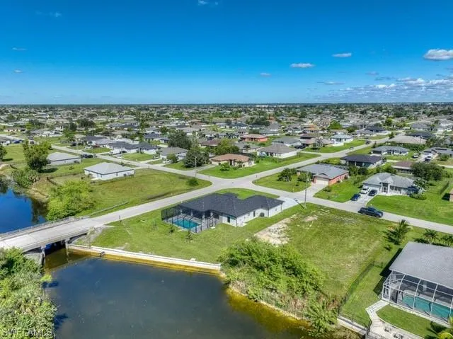 Aerial view of residential area with a nearby body of water and a notable bridge
