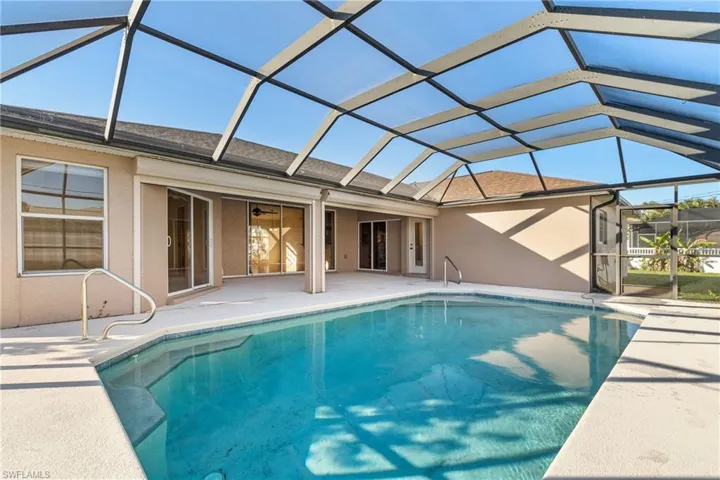 View of pool featuring a patio and screen enclosure