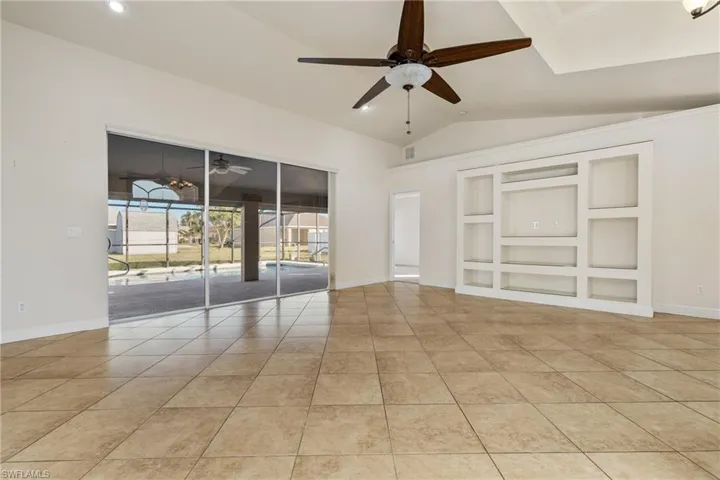 Large bank of sliders leading to the screened lanai and pool area