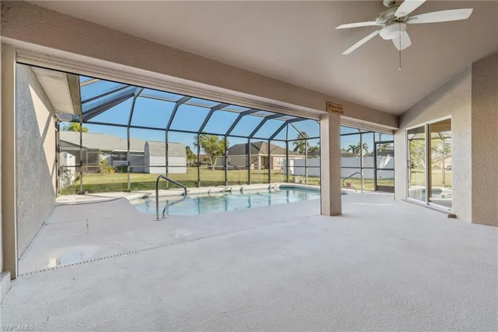 View of pool with ceiling fan, a yard, and a patio area