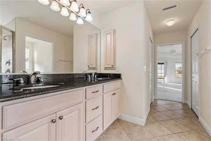 Master Bathroom with tile floors, dual sinks vanity, and walk in shower