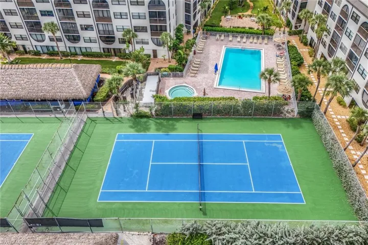 Drone / aerial view of apartment complex / building and a pool