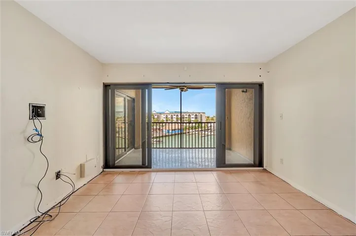 Unfurnished room with light tile patterned flooring and baseboards