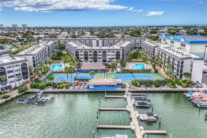 Aerial view of a pool area and a nearby body of water