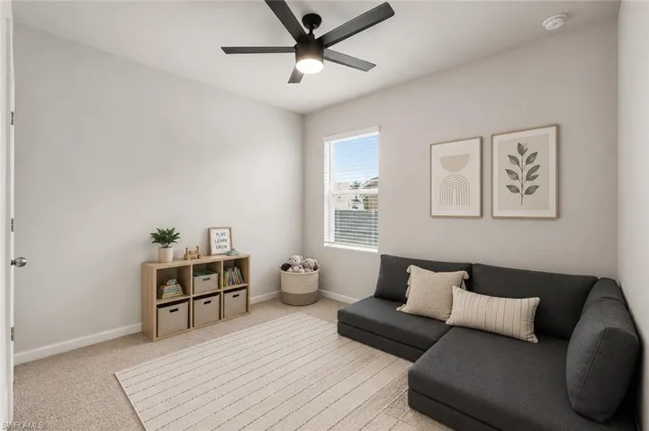 Spacious room featuring neutral carpeting, light-colored walls, and a ceiling fan with integrated lighting. Edited with AI.