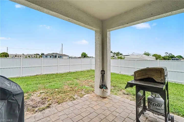 Covered patio featuring a paver floor and textured ceiling