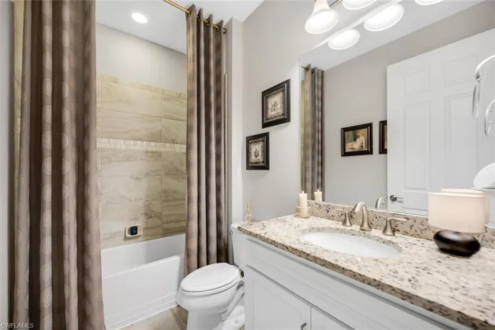Bathroom with shower / tub combo and vanity