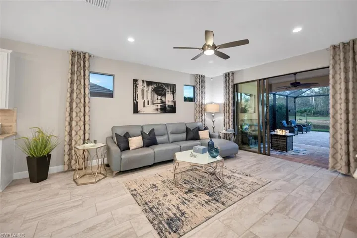Living area with recessed lighting, plenty of natural light, and a ceiling fan