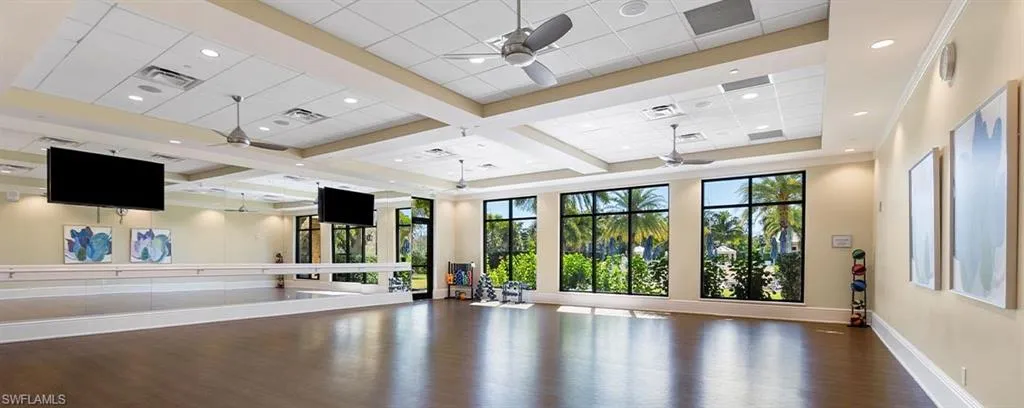 Workout area with ceiling fan, coffered ceiling, beam ceiling, a drop ceiling, and recessed lighting