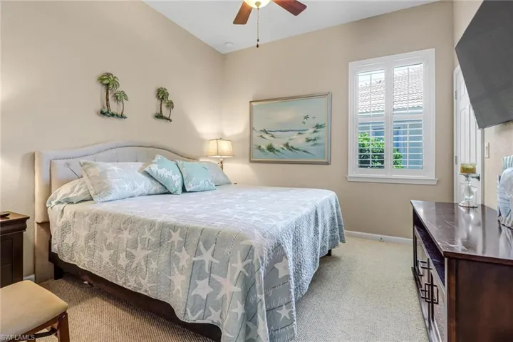 Carpeted bedroom with ceiling fan
