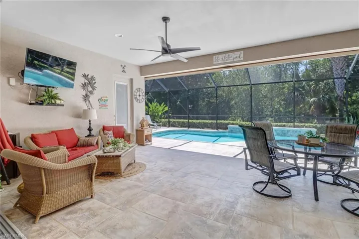 View of pool with ceiling fan