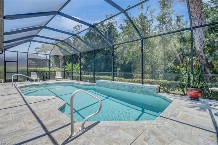 View of swimming pool featuring a lanai and a patio area