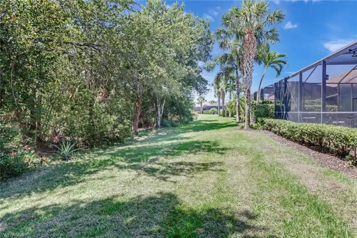 View of yard featuring glass enclosure