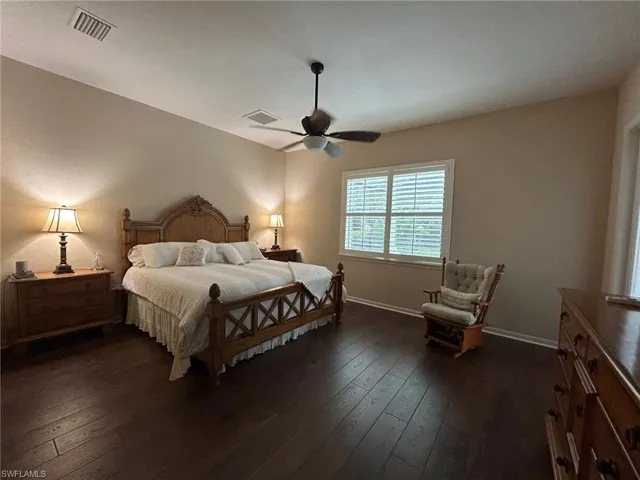 Bedroom with dark wood-type flooring and ceiling fan