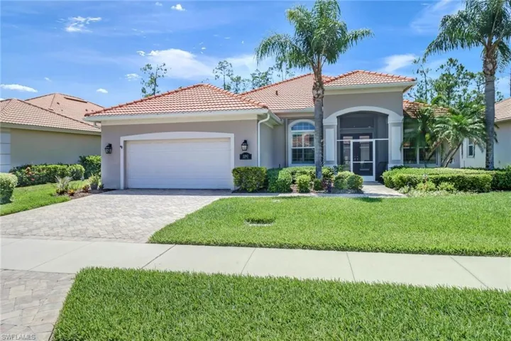 Mediterranean / spanish-style house featuring a front yard and a garage