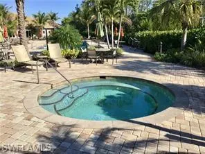 View of pool with a community hot tub and a patio