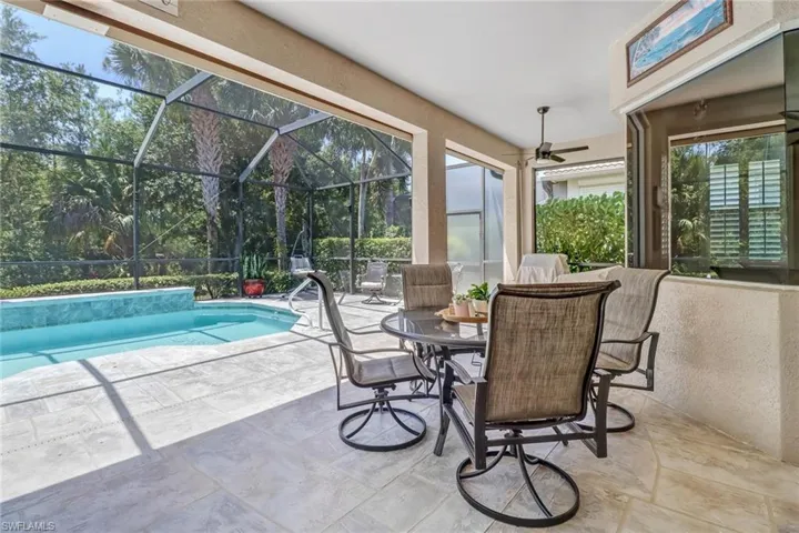 Sunroom / solarium featuring a wealth of natural light, a hot tub, and ceiling fan
