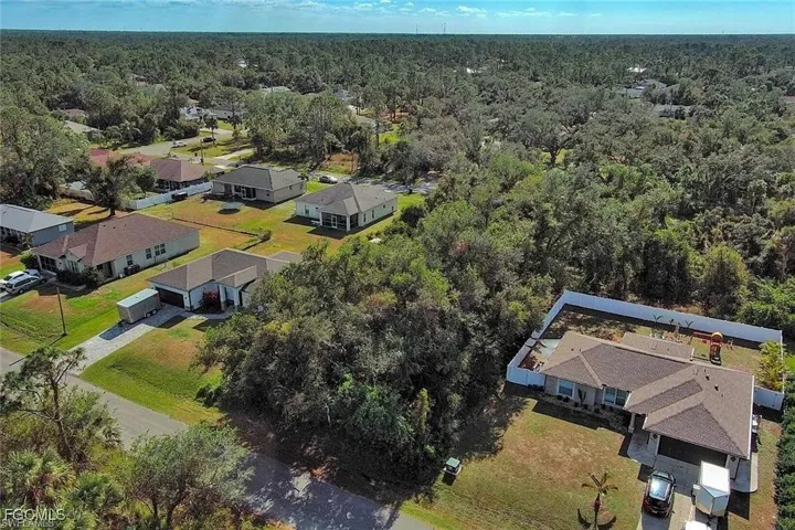 Aerial overview of property's location featuring a heavily wooded area and nearby suburban area