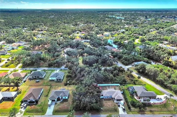 Aerial view of property's location with nearby suburban area