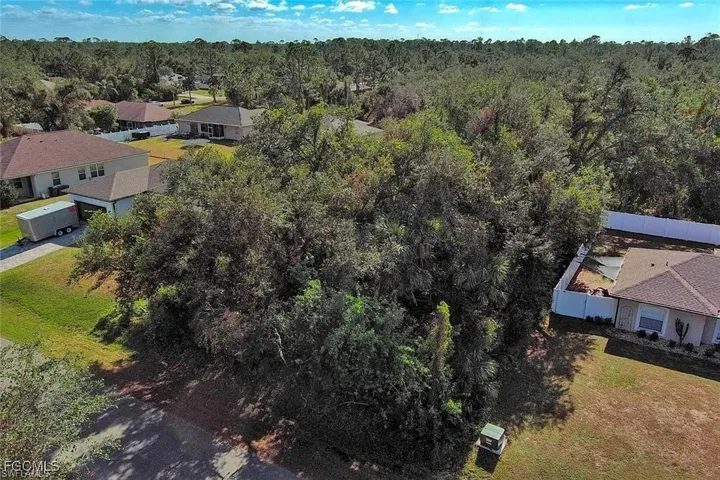 Aerial view of property's location with nearby suburban area