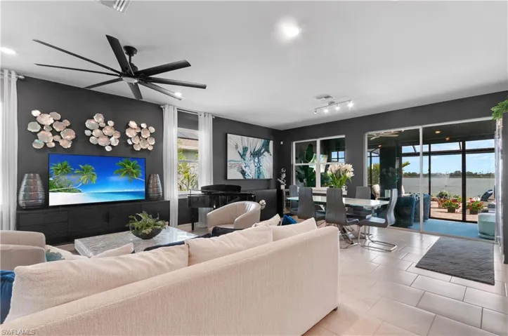 Spacious interior featuring tile flooring, dark accent walls, and a multi-blade ceiling fan
