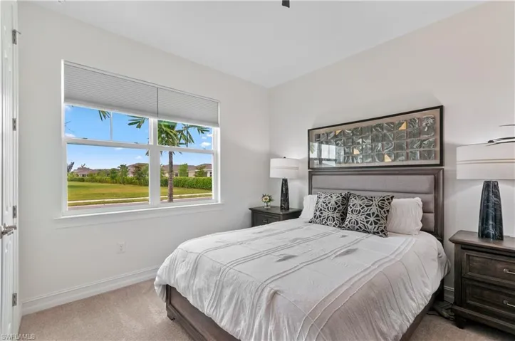 Bright interior space with a large window featuring horizontal blinds