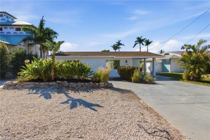 Single story home featuring concrete driveway and stucco siding