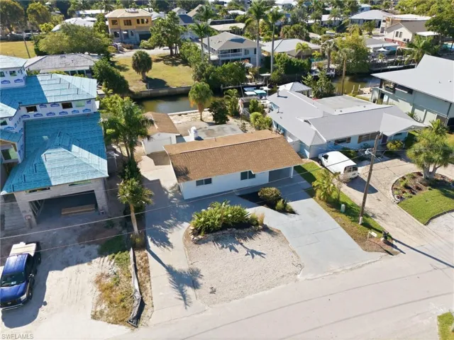 Aerial perspective of suburban area featuring a large body of water
