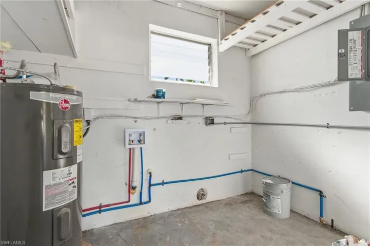 Garage with water heater and electric panel